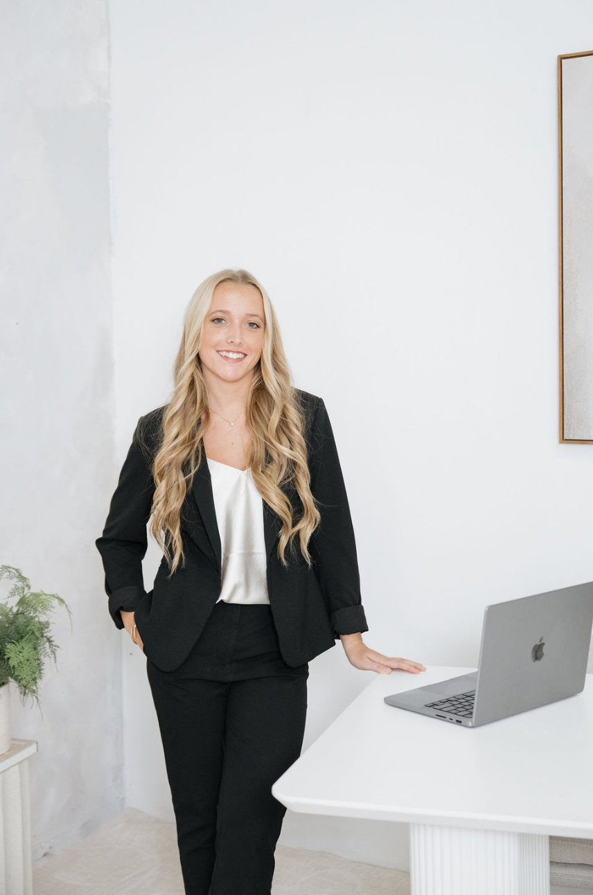 Founder of Banana River Marketing standing at a desk with a laptop